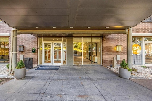 view of exterior entry with a patio and french doors