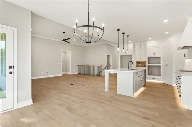 kitchen featuring a kitchen island with sink, sink, decorative light fixtures, light hardwood / wood-style floors, and white cabinetry