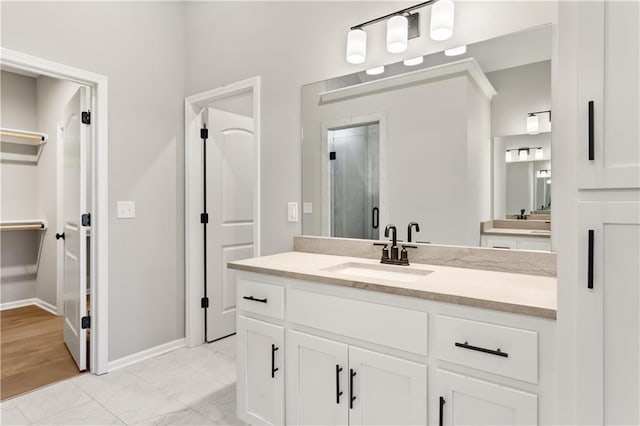 bathroom featuring vanity and a shower with shower door