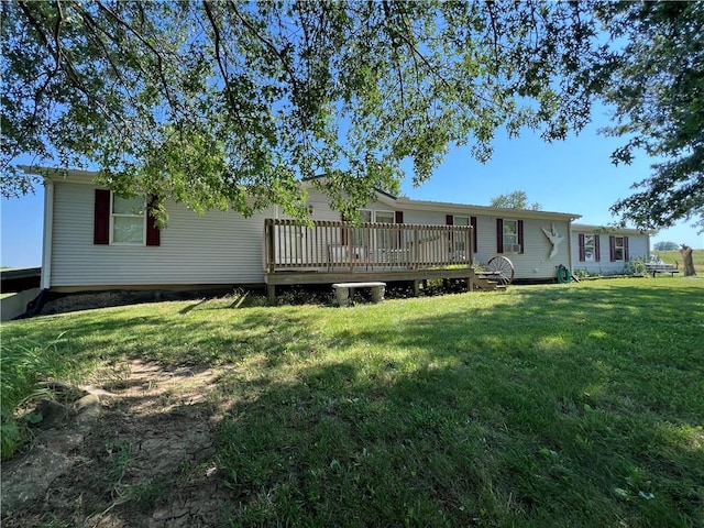 back of house with a wooden deck and a yard