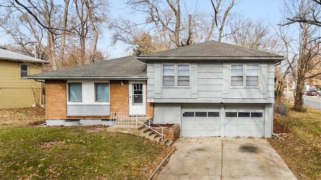 split level home featuring a front yard and a garage