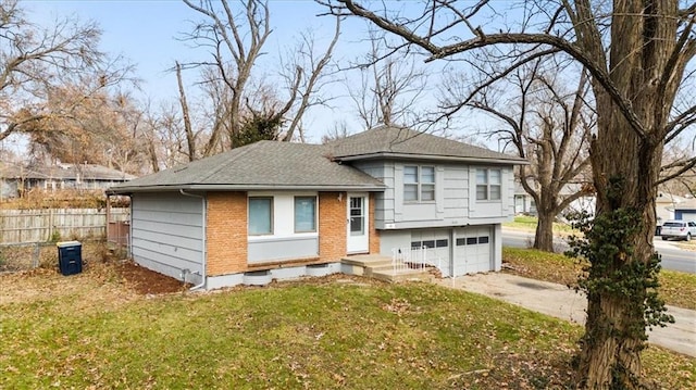 view of front of house with a front yard and a garage