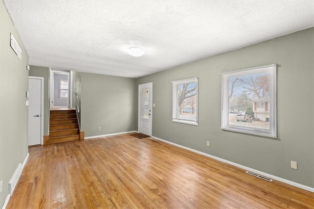 interior space featuring a textured ceiling and light hardwood / wood-style flooring