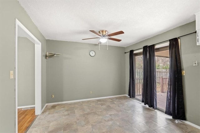 spare room with a textured ceiling and ceiling fan