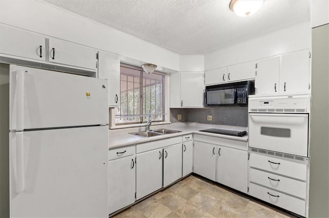 kitchen with black appliances, white cabinetry, sink, and a textured ceiling