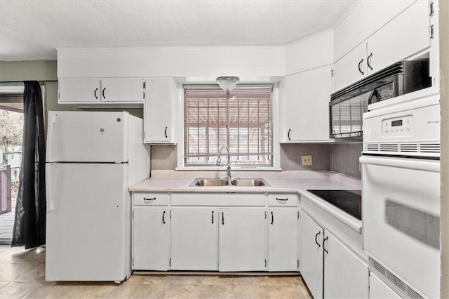 kitchen with white cabinetry, sink, and white appliances