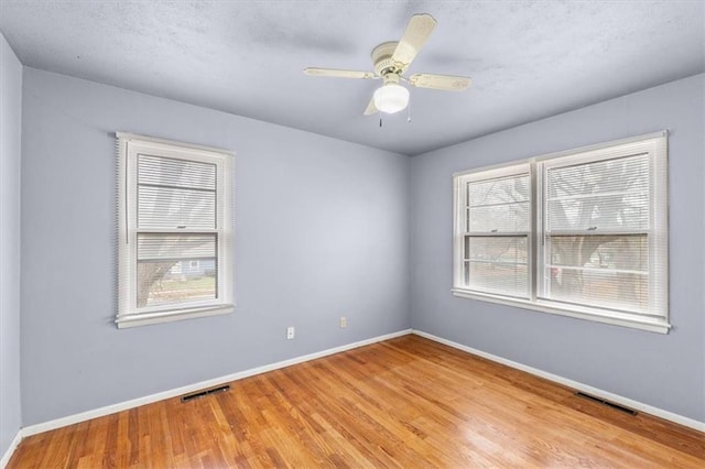 unfurnished room with ceiling fan and light hardwood / wood-style flooring