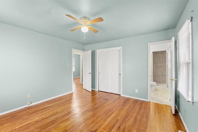 unfurnished bedroom with ceiling fan, ensuite bathroom, and light wood-type flooring