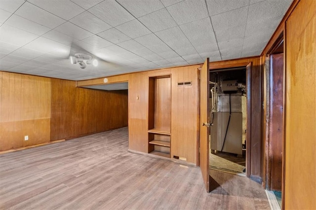 basement featuring wood-type flooring and wooden walls