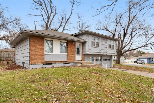 tri-level home with a garage and a front lawn