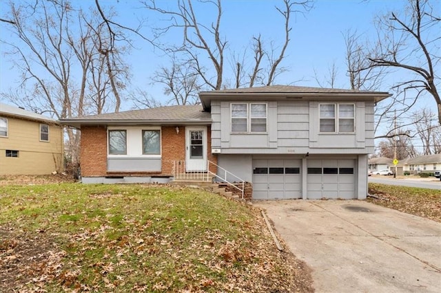 split level home featuring a garage and a front lawn