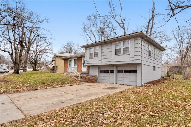 tri-level home featuring a garage and a front lawn