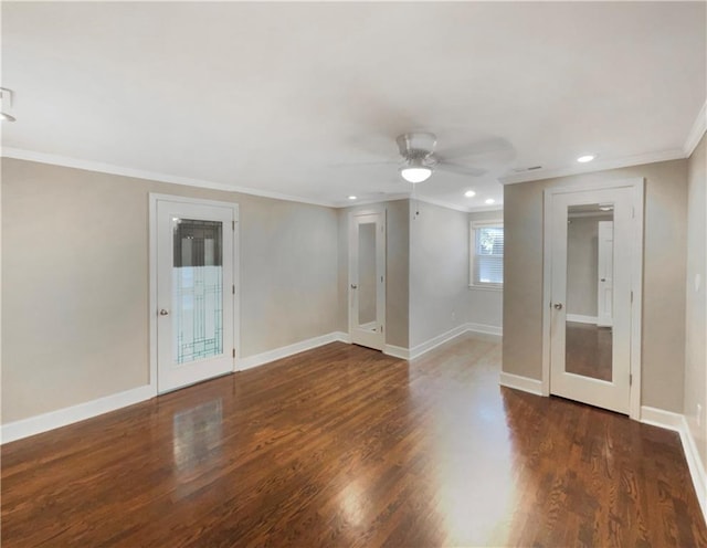 spare room with dark wood-type flooring, ceiling fan, and crown molding