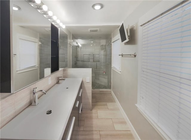 bathroom with an enclosed shower and vanity