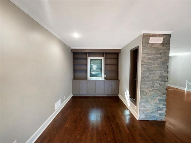 empty room featuring dark hardwood / wood-style floors and crown molding