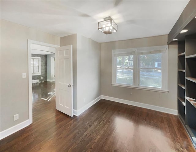 unfurnished dining area featuring dark hardwood / wood-style flooring