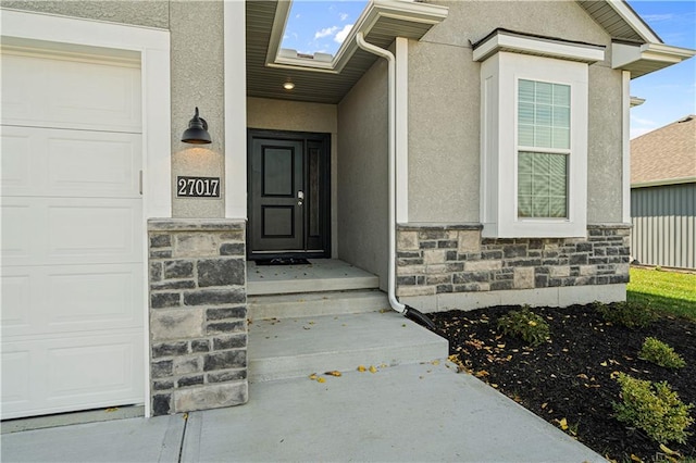 doorway to property with a garage