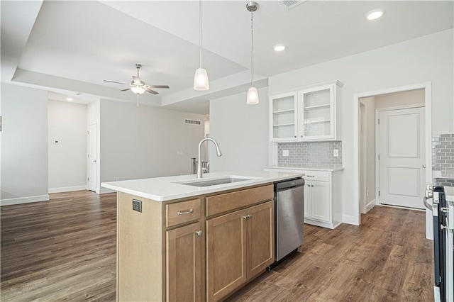 kitchen featuring a kitchen island with sink, dark wood-type flooring, sink, appliances with stainless steel finishes, and white cabinetry