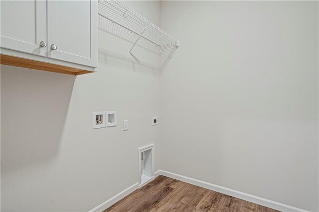 27017 E Olive Dr, Lees Summit, MO 64086 - laundry room with electric dryer hookup, washer hookup, cabinet space, wood finished floors, and baseboards