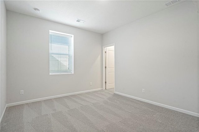 spare room with light colored carpet