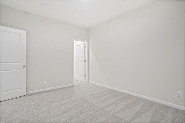 27017 E Olive Dr, Lees Summit, MO 64086 - spare room featuring carpet floors and baseboards