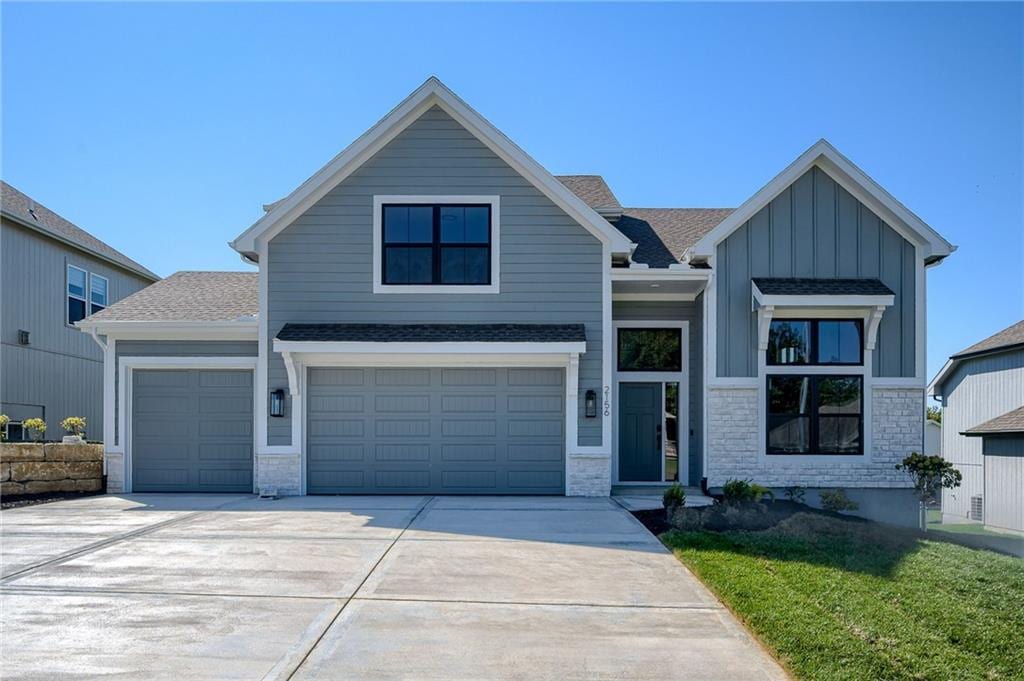 view of front of home featuring a garage and a front lawn