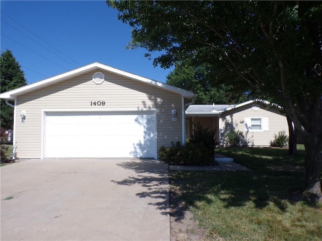 ranch-style house with a garage and a front lawn