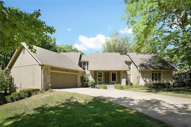 view of front of home with a garage and a front lawn