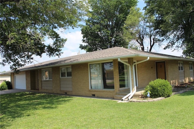 ranch-style home with a garage and a front lawn