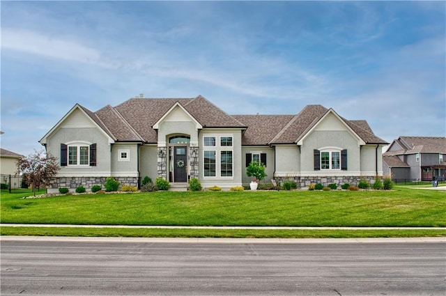 french country inspired facade with a front lawn