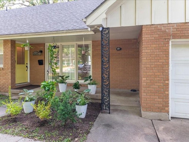 entrance to property featuring a garage and a porch