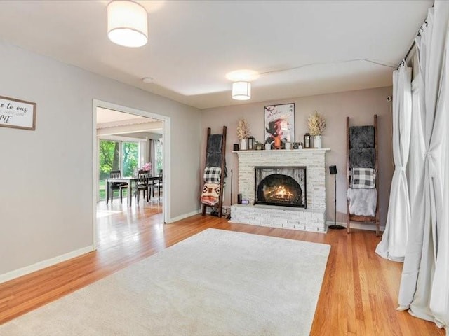 living room with hardwood / wood-style floors and a fireplace