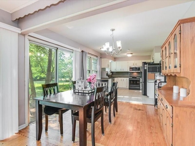 dining area featuring light hardwood / wood-style flooring and a notable chandelier