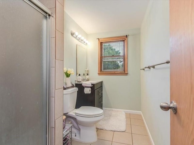 bathroom featuring toilet, vanity, tile patterned flooring, and an enclosed shower