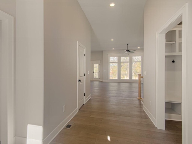 hall with hardwood / wood-style floors