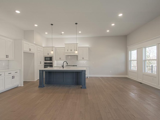 16430 NW 123rd St, Platte City, MO 64079 - kitchen featuring light countertops, oven, built in microwave, and backsplash