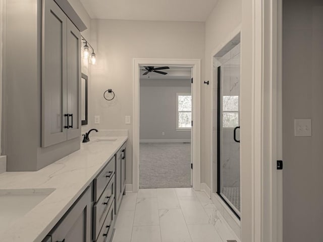 bathroom featuring vanity, ceiling fan, and an enclosed shower