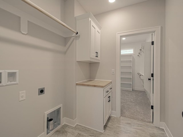 laundry room featuring hookup for an electric dryer, washer hookup, and cabinets