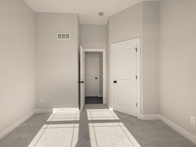 empty room featuring light colored carpet