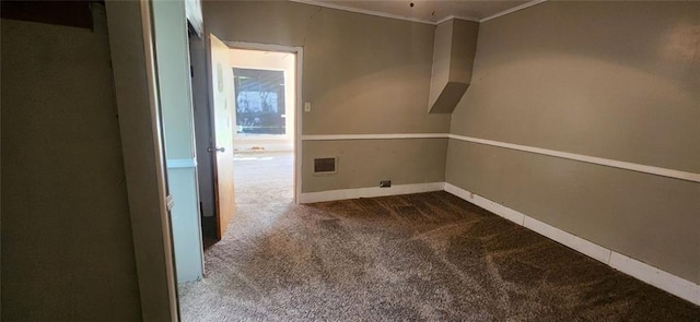 empty room with crown molding and carpet