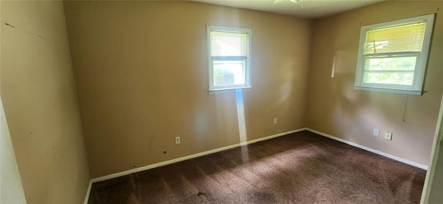 carpeted spare room featuring a healthy amount of sunlight