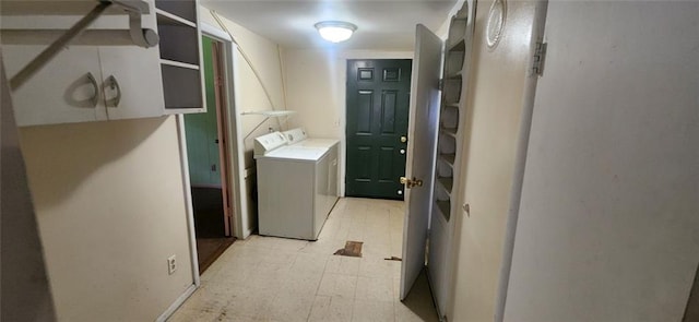 washroom featuring light tile floors and washing machine and dryer