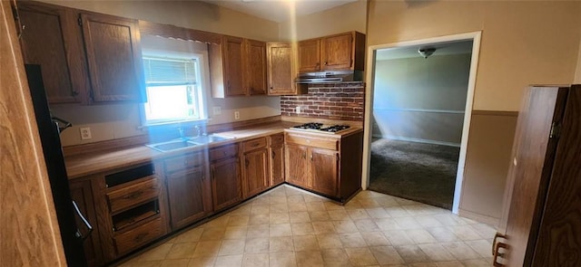 kitchen featuring light colored carpet, sink, and stainless steel gas stovetop