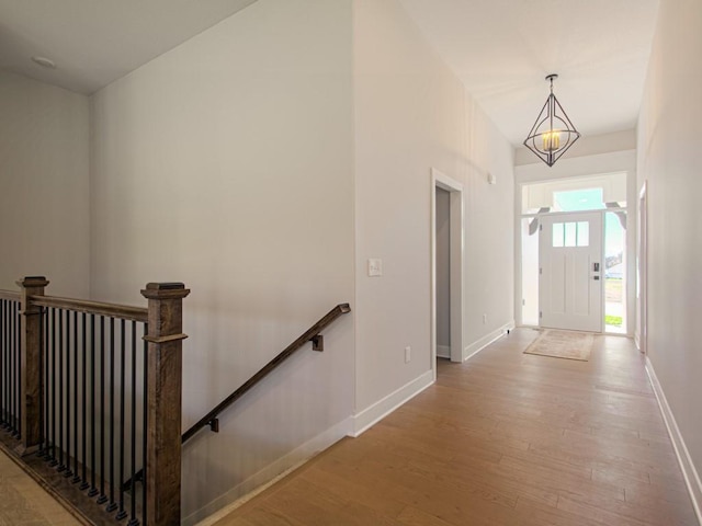 12435 Appaloosa St, Platte City, MO 64079 - foyer with wood finished floors, baseboards, and a chandelier