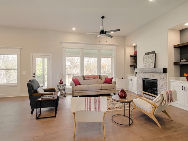 12435 Appaloosa St, Platte City, MO 64079 - living room with light wood finished floors, a ceiling fan, a fireplace, recessed lighting, and baseboards