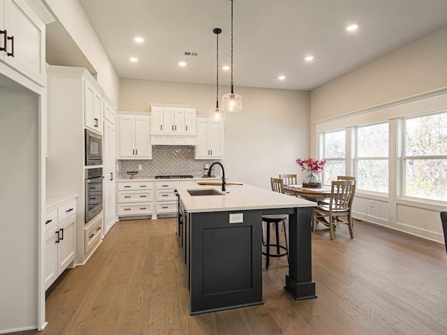 12435 Appaloosa St, Platte City, MO 64079 - kitchen with oven, a sink, tasteful backsplash, light countertops, and recessed lighting