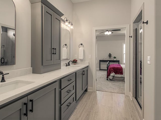 12435 Appaloosa St, Platte City, MO 64079 - full bathroom featuring a ceiling fan, double vanity, connected bathroom, and a shower stall