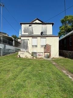 rear view of house with a yard