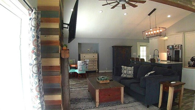 living room featuring recessed lighting, ceiling fan with notable chandelier, wood finished floors, and vaulted ceiling