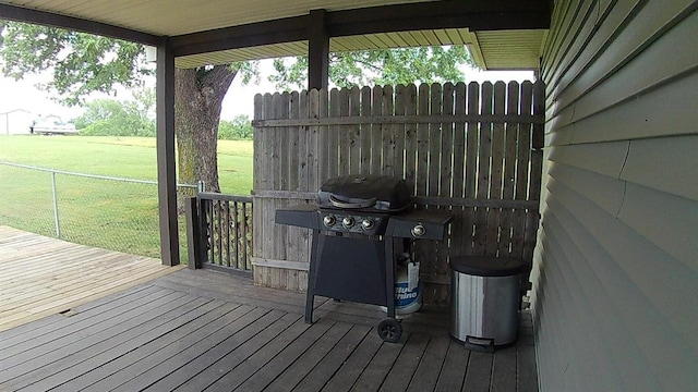 deck with a yard, fence, and grilling area